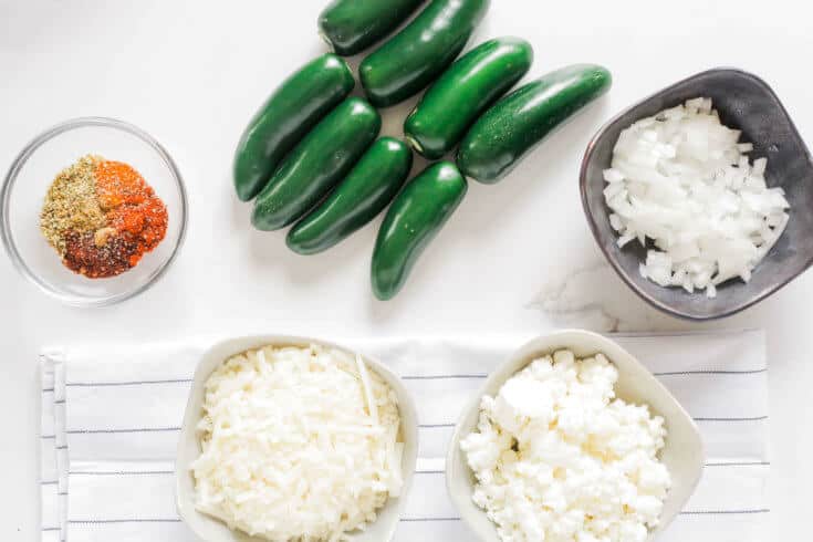 A close-up of stuffed jalapeño peppers with turkey bacon